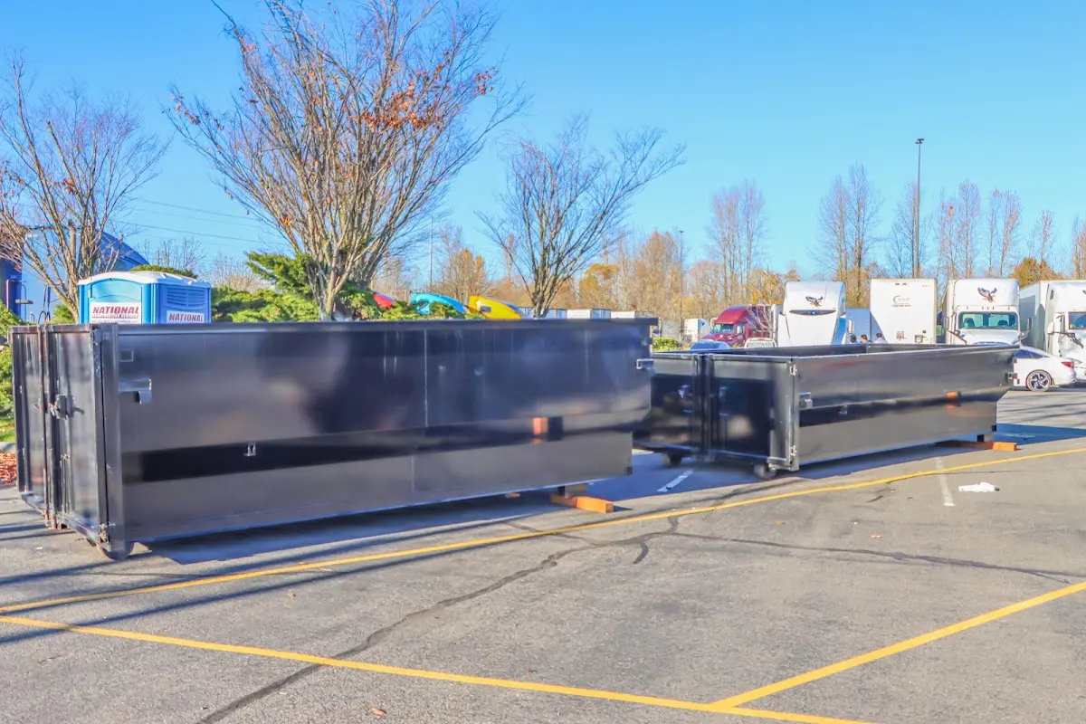 Professional dumpster rental service with roll-off container on residential driveway in San Luis Obispo